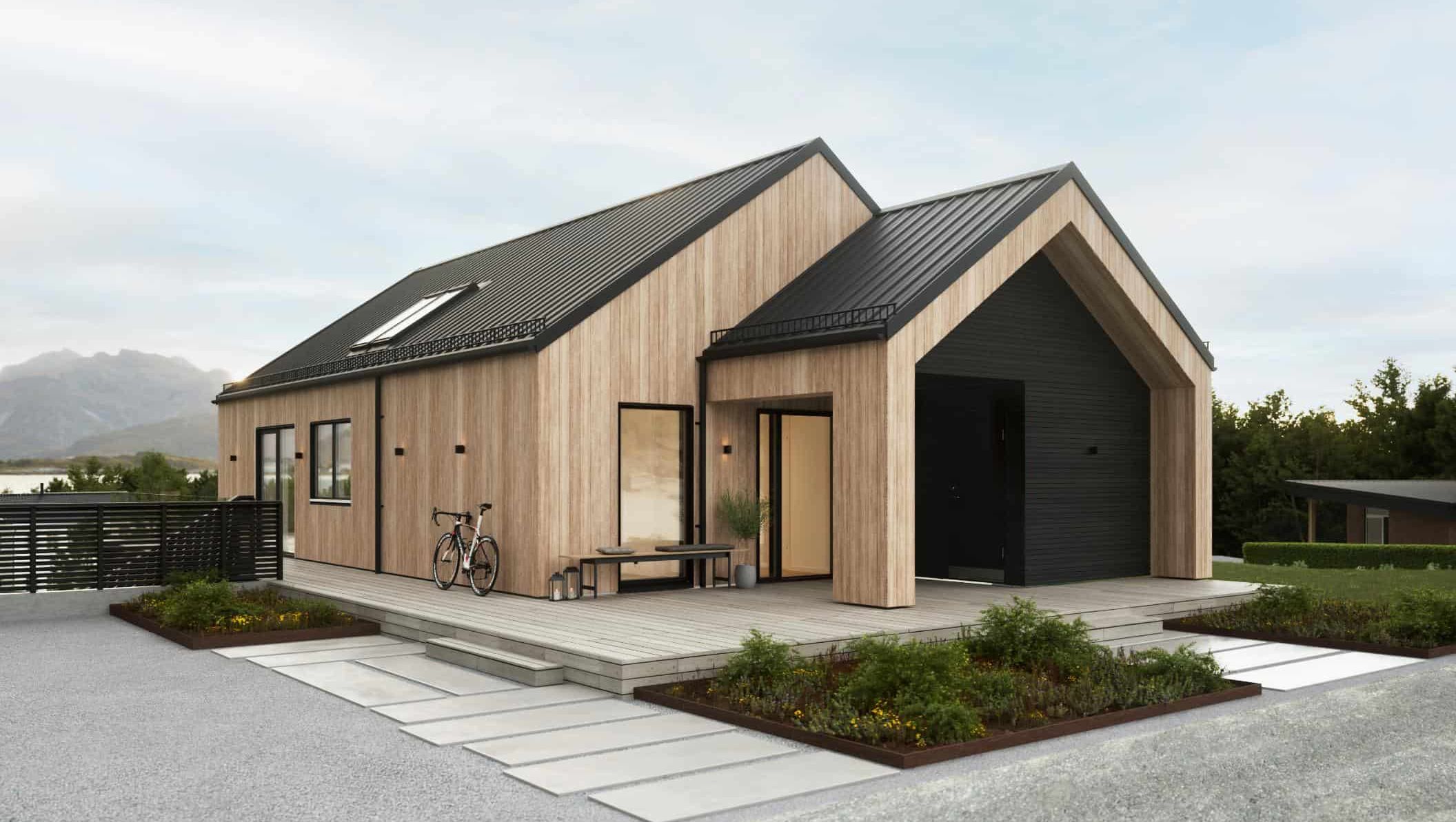 Moderne enebolig med saltak og fasade i treverk, stor terrasse og sykkel stående ved inngangspartiet.