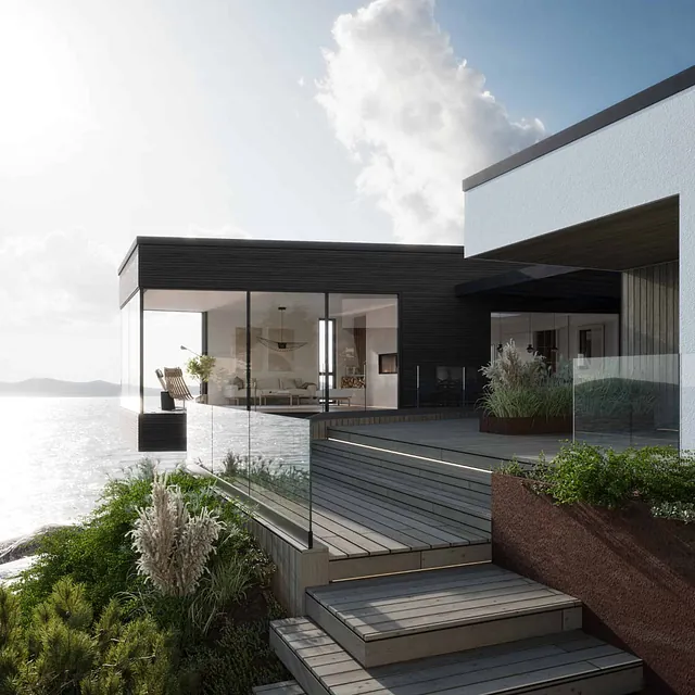 Moderne funkisinspirert hus ved vannet, med store glassflater og terrassetrapp ned mot hage.